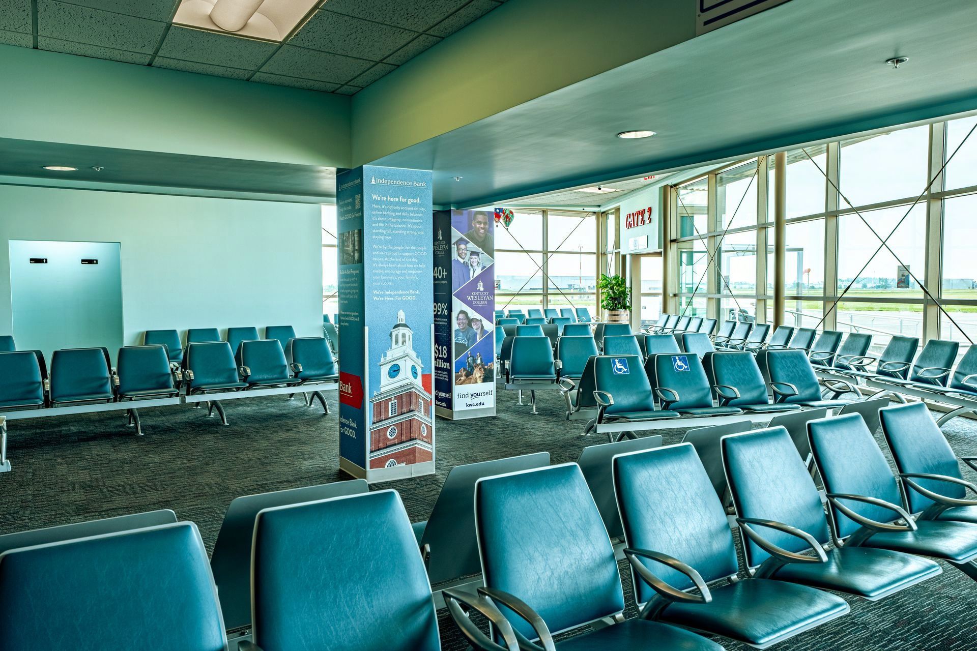 A row of blue chairs in an airport waiting area
