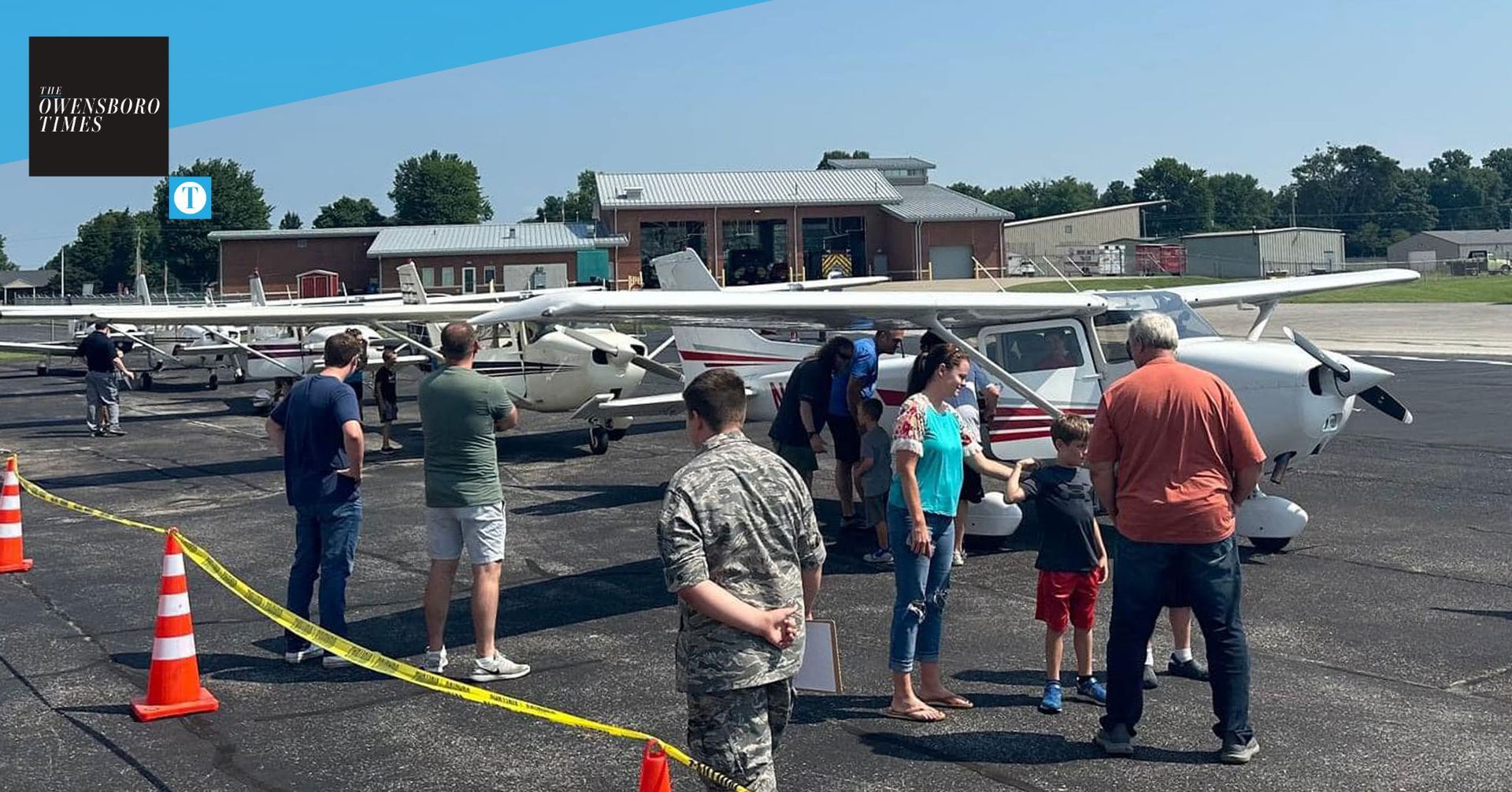 A group of people are standing in front of an airplane
