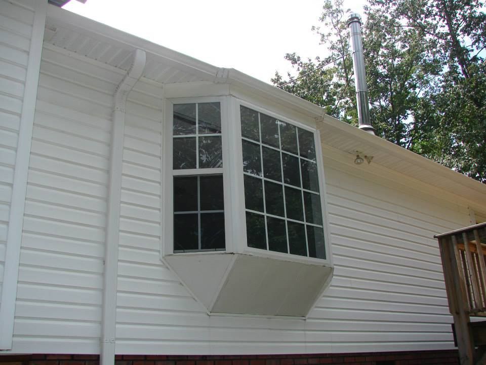 A white house with a bay window on the side