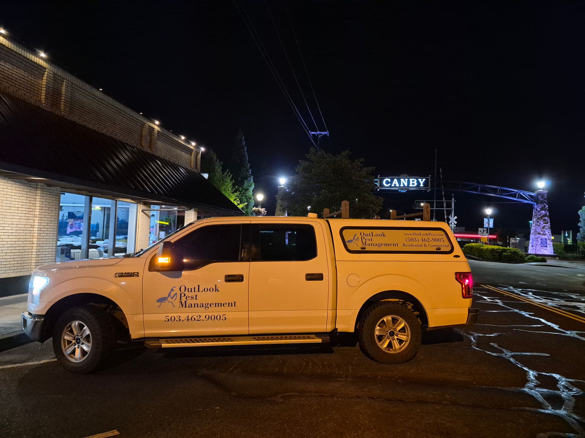 We offer ocal pest control in Canby, OR for homes and business OutLook Service vehicle infront of the Canby arch.