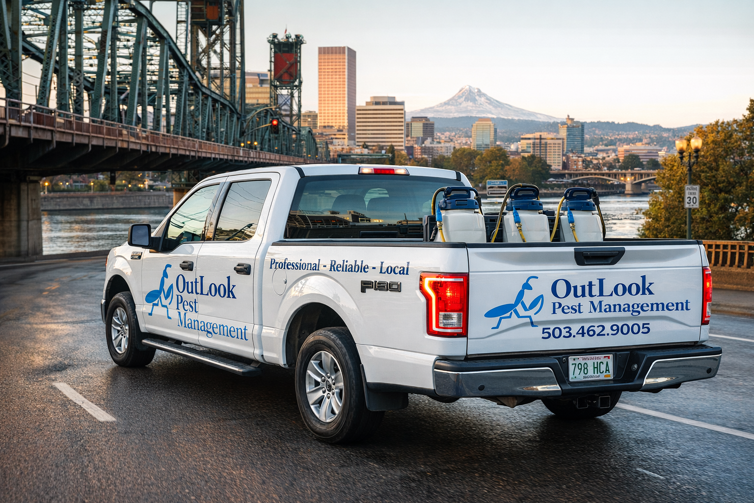 White 2016 Ford F-150 truck with OutLook Pest Management branding driving through Portland, Oregon at dusk, carrying stainless pump sprayers in the bed, with the city skyline, bridge, and Mount Hood in the background.
