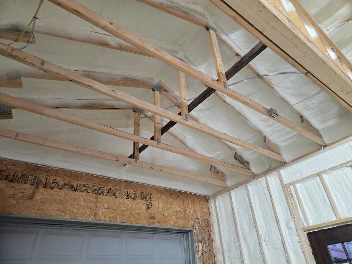 A room with a ceiling that is covered in foam and wooden beams.