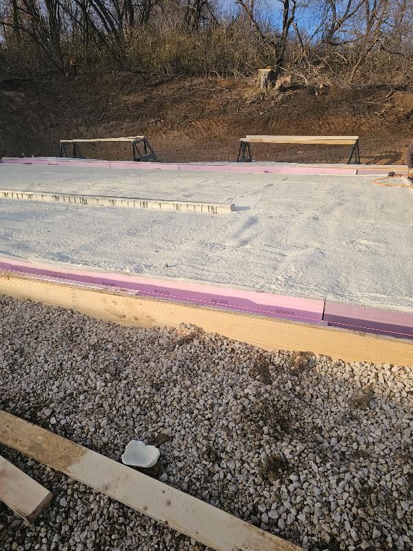 A concrete slab is being built on top of a gravel ground.