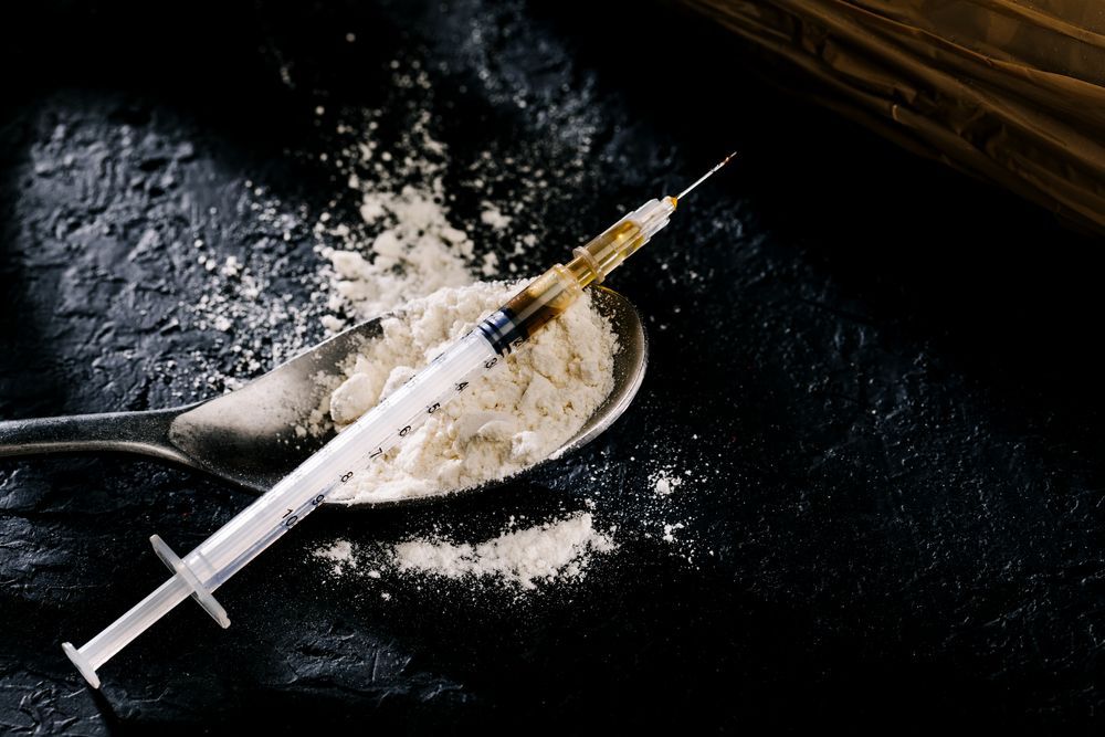 Heroin in a syringe and heroin powder 