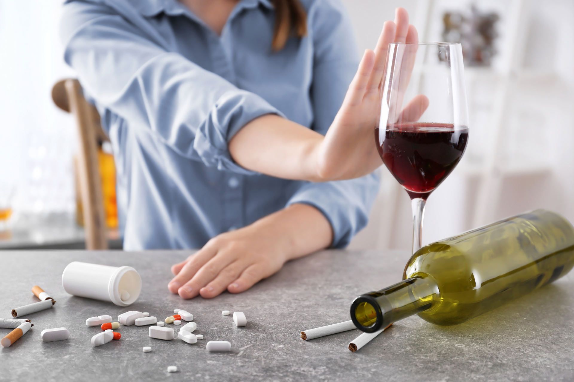 Young woman refusing glass of wine