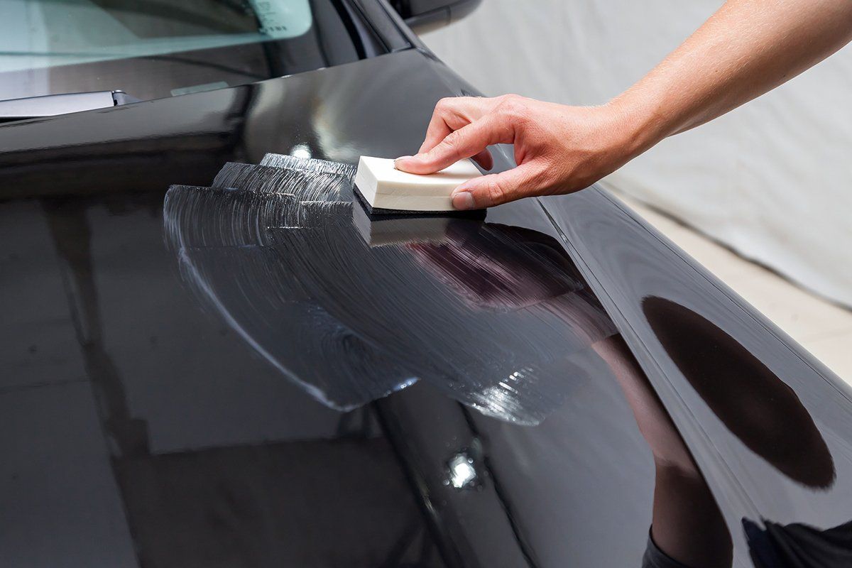 Person Applying Ceramic Coating On Car — Plymouth, MN — Sheen Auto Spa LLC Person Applying Ceramic Coating On Car — Plymouth, MN — Sheen Auto Spa LLC