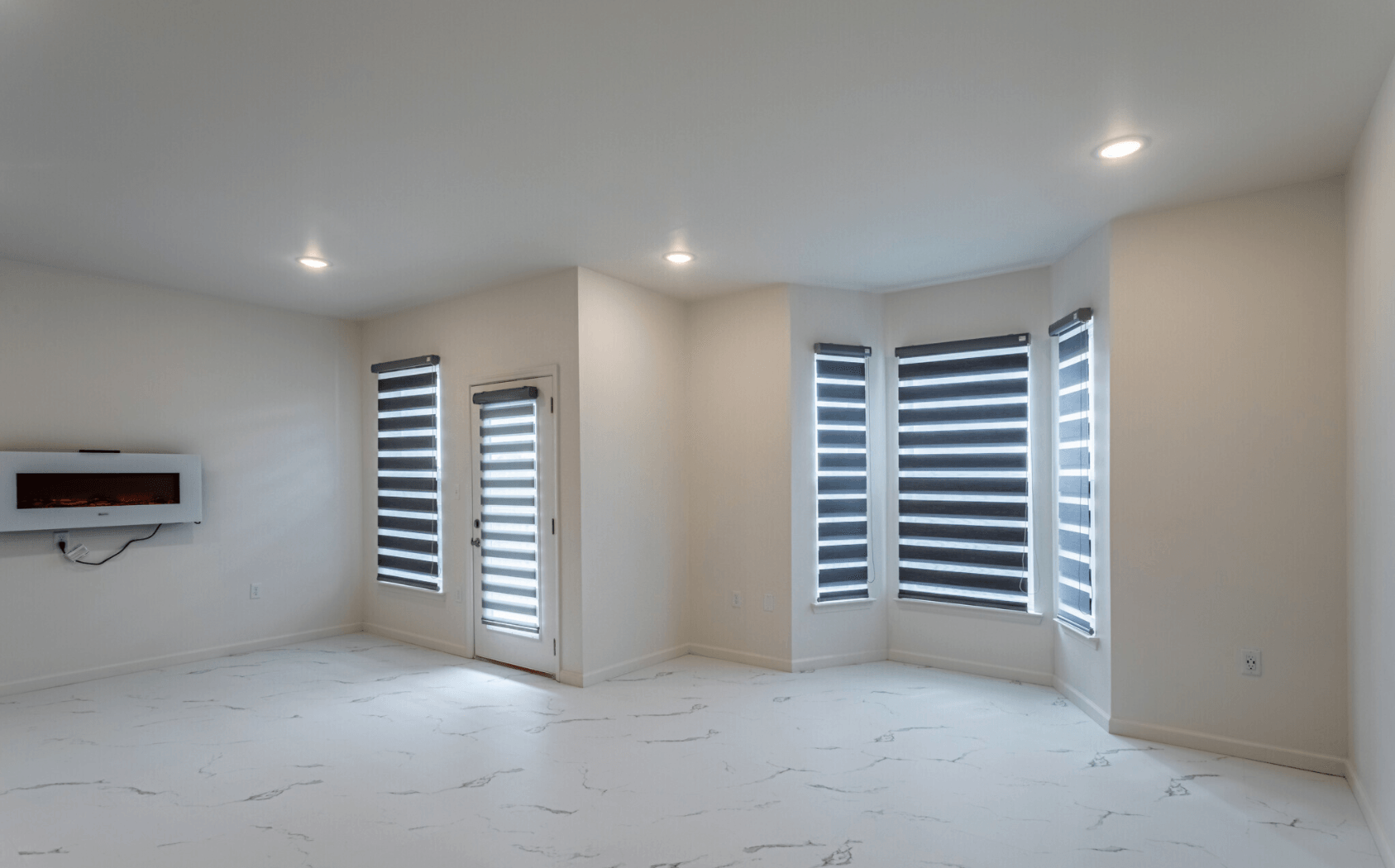 Interior of living room with large blind covered windows