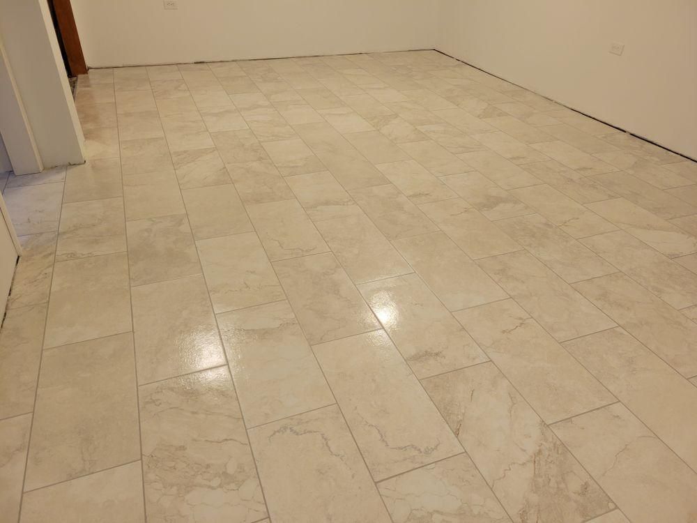 Empty tiled room with beige walls and a light marble-pattern floor