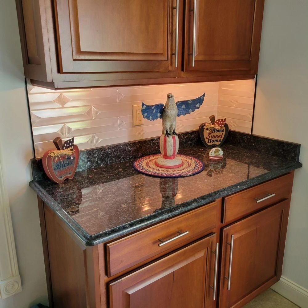Kitchen corner with dark granite countertop and wooden cabinets