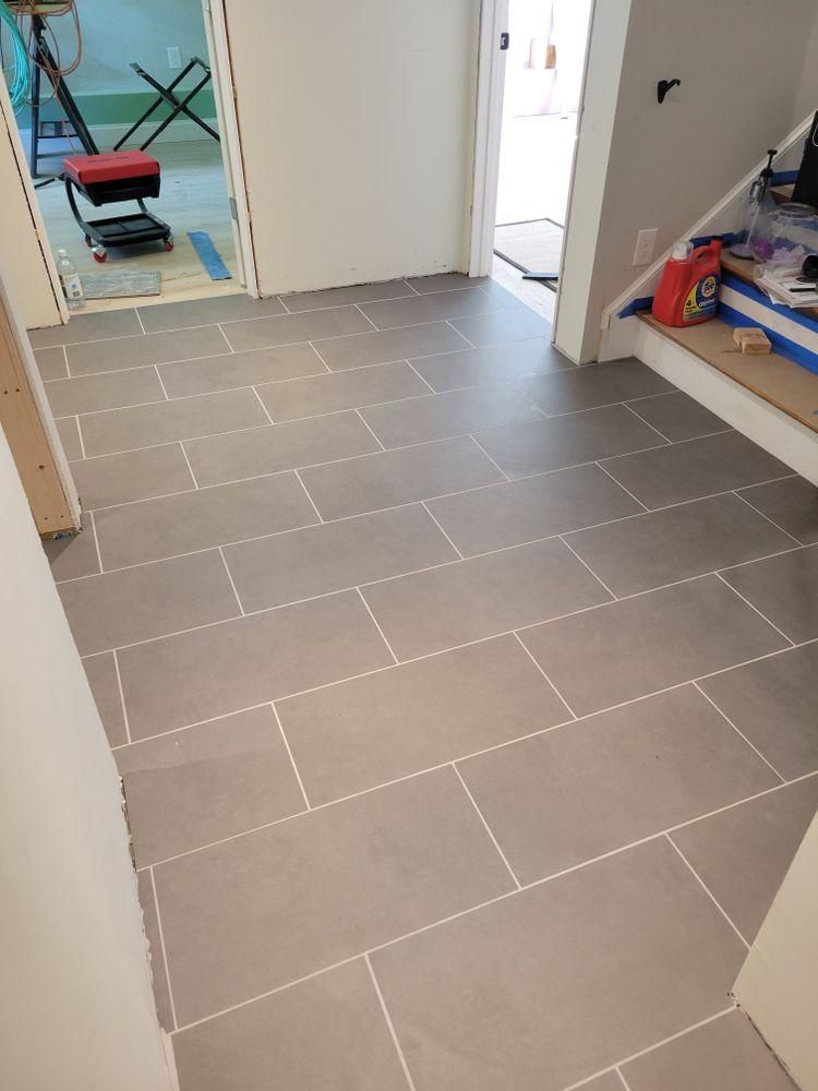 Newly tiled hallway with gray floor tiles, white walls
