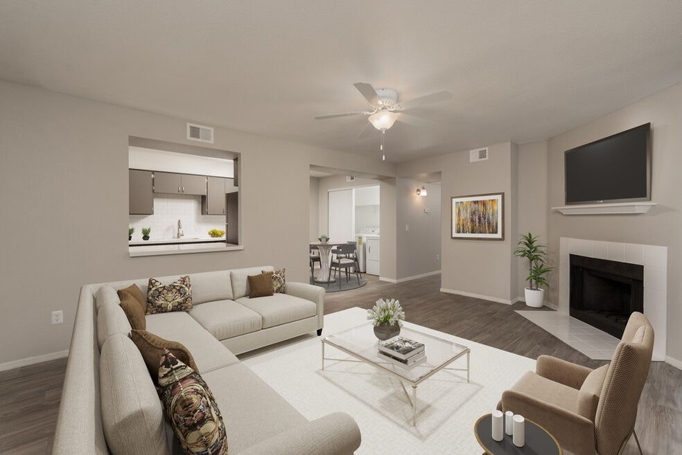 Living room with sectional sofa, fireplace, and open kitchen.