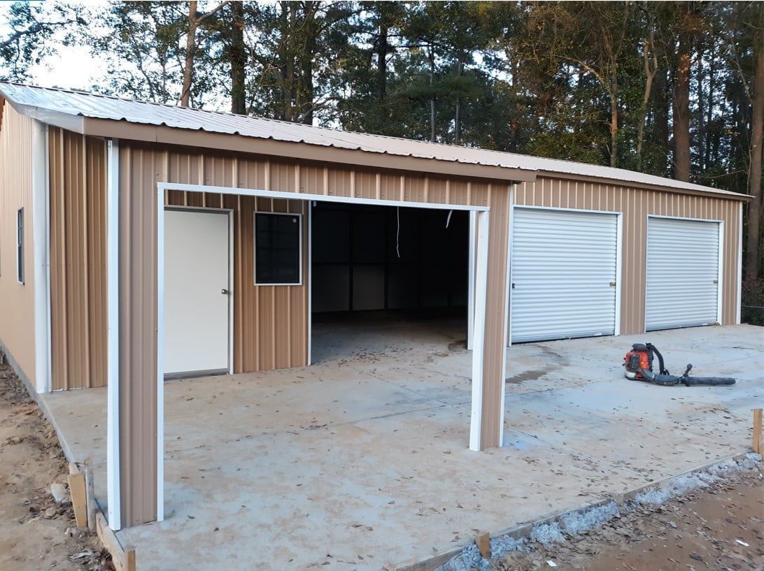 A garage with a lawn mower in front of it