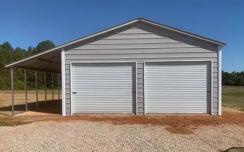 A white garage with two garage doors and a carport.
