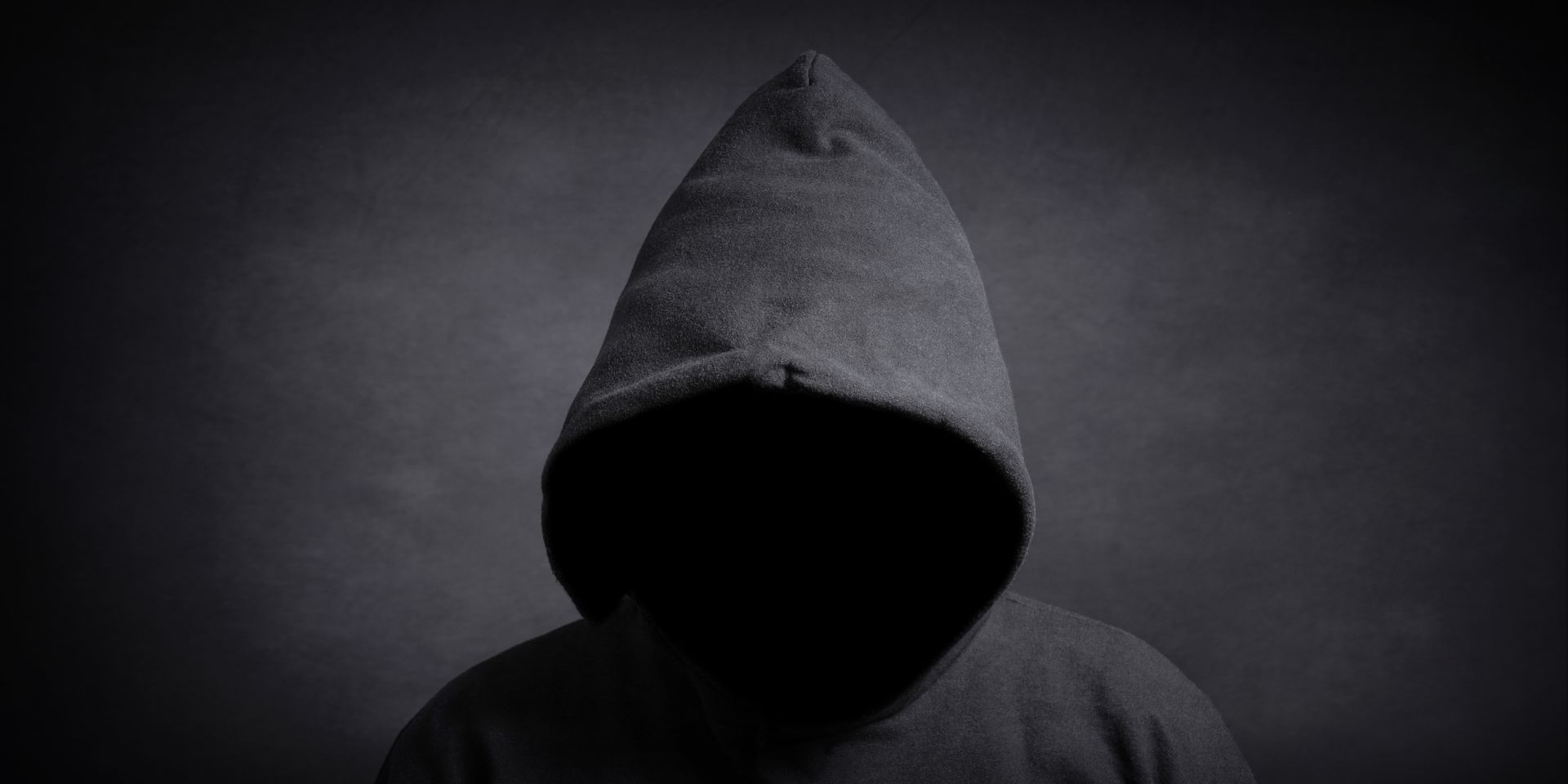 man in hood committing felony 