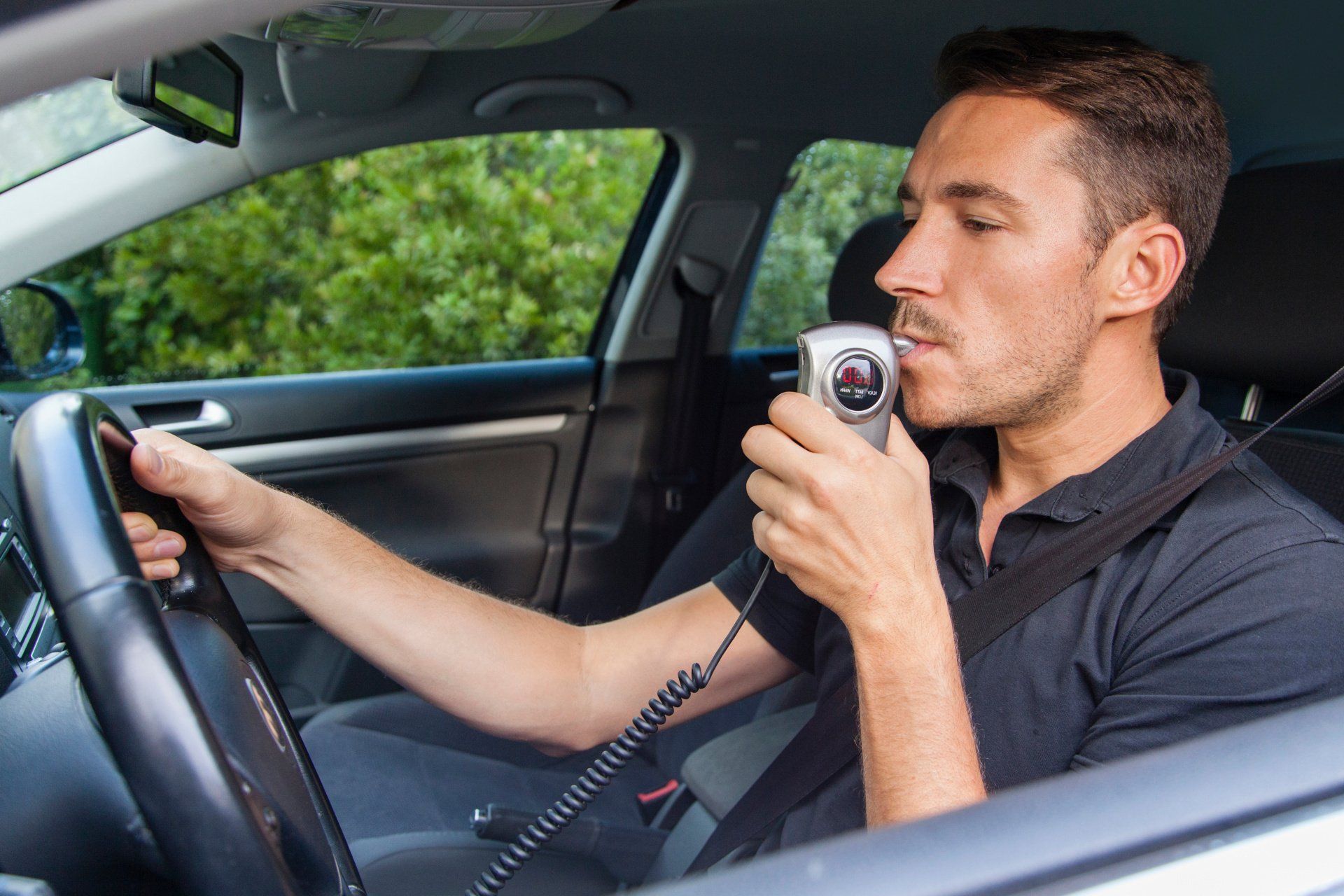 man using a breathalyzer