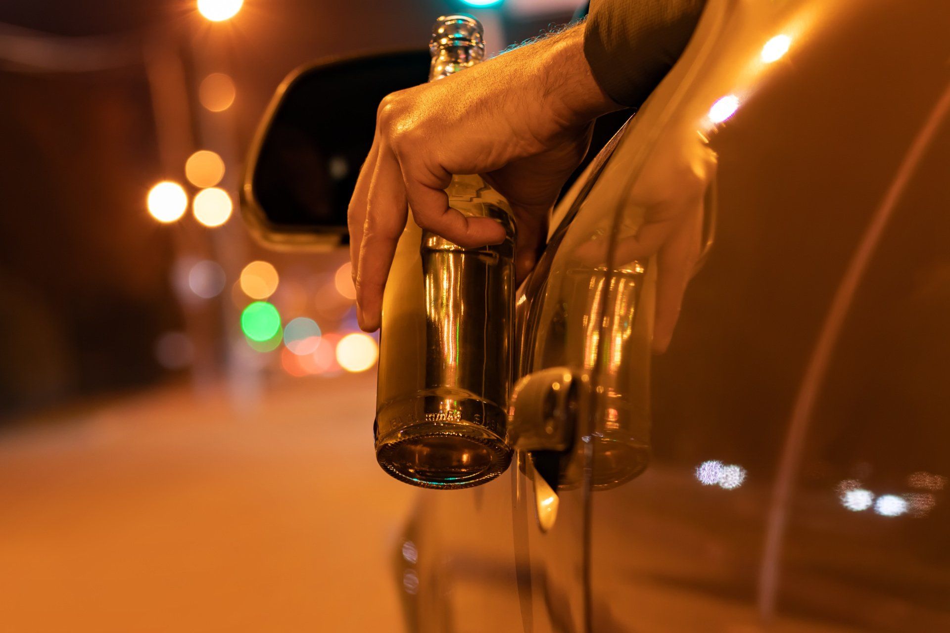 man with beer in car