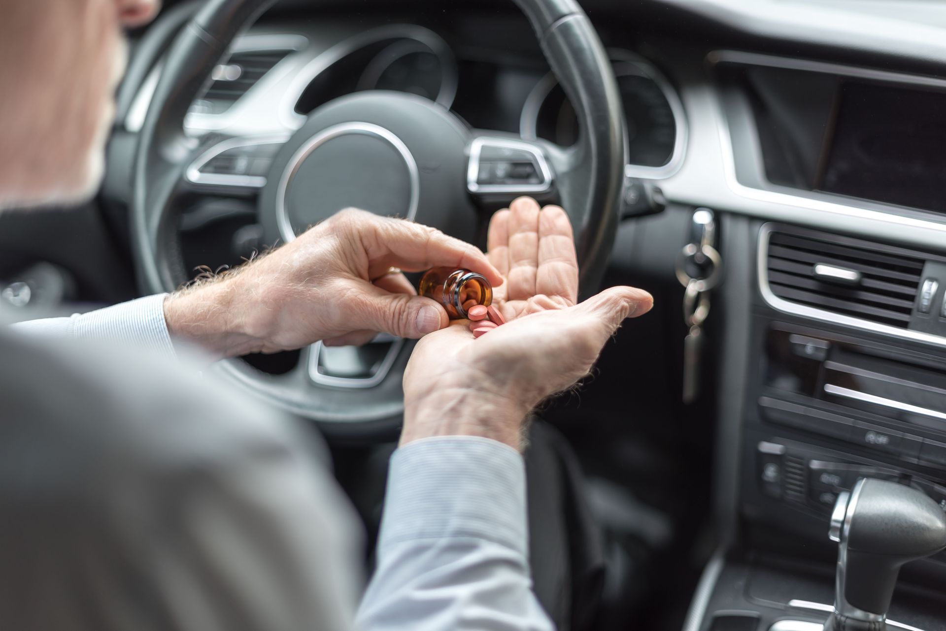 person taking medication while driving