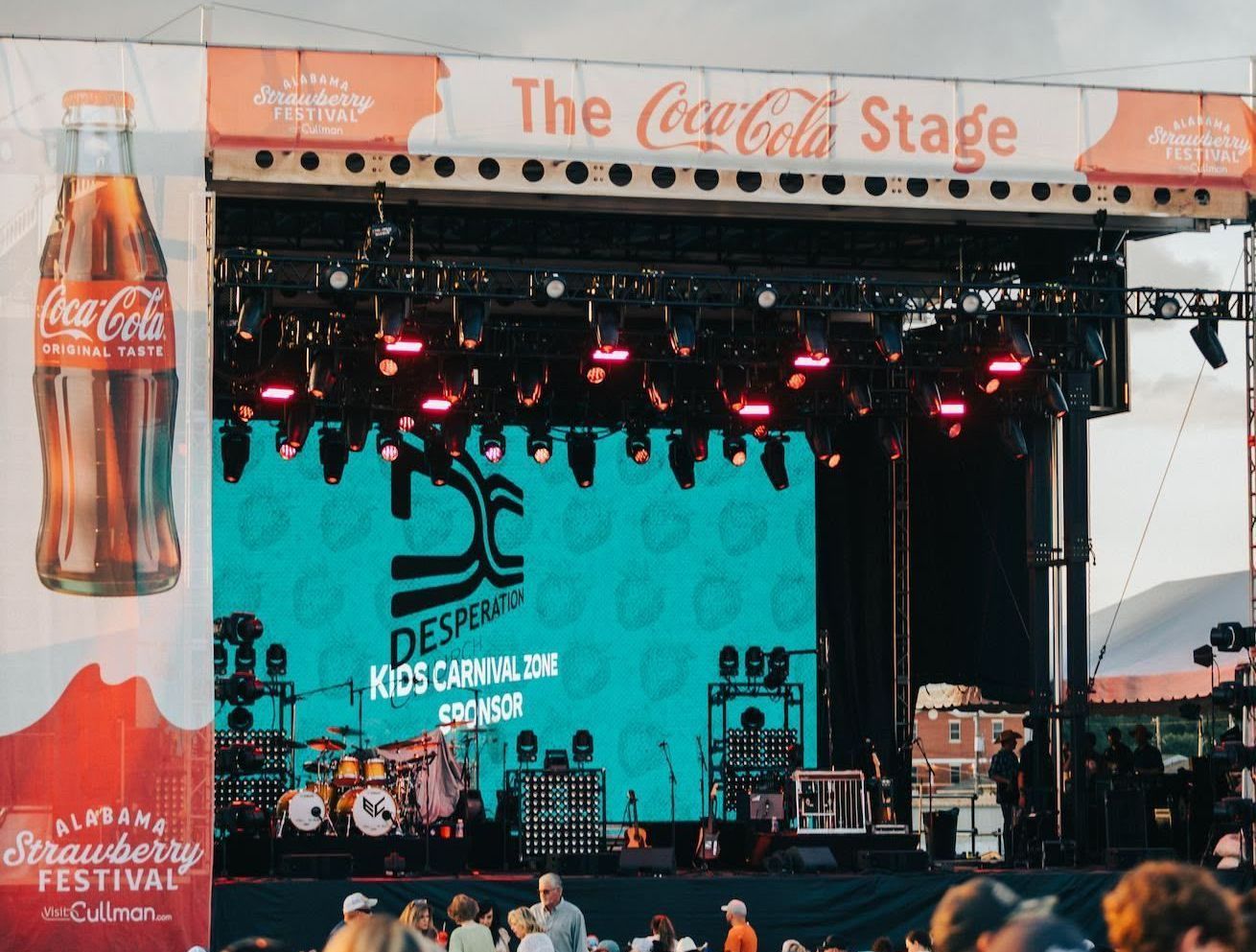 A stage with a coca cola advertisement on it