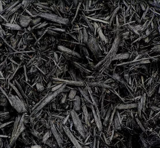 A close up of black dyed mulch