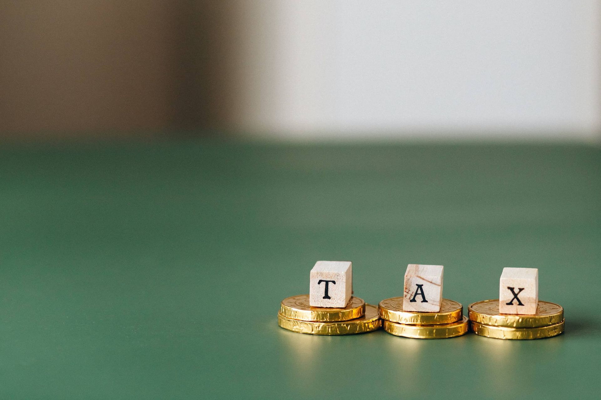 A stack of gold coins with the word tax written on them.
