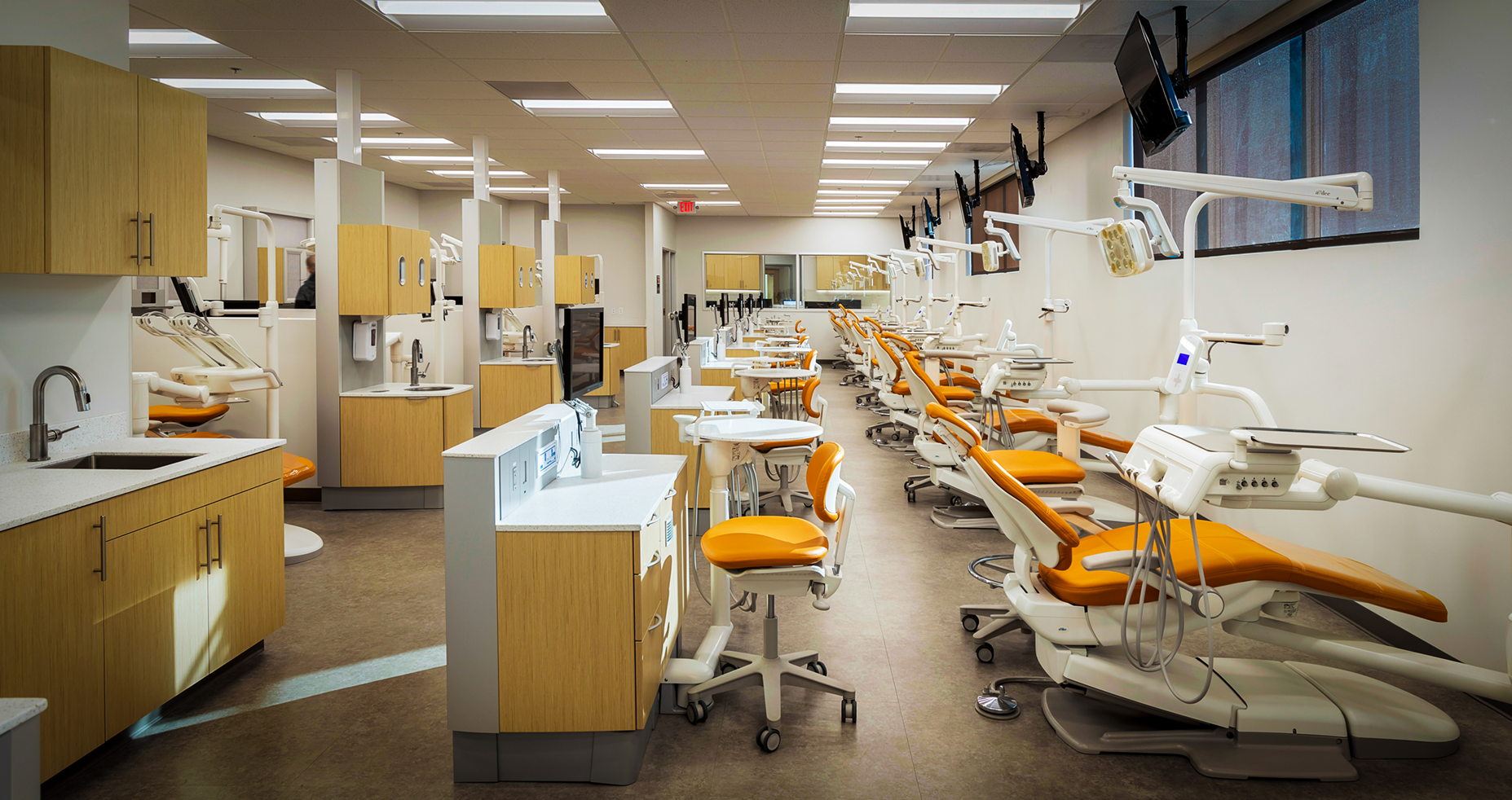 A dental office with a lot of dental chairs and instruments.