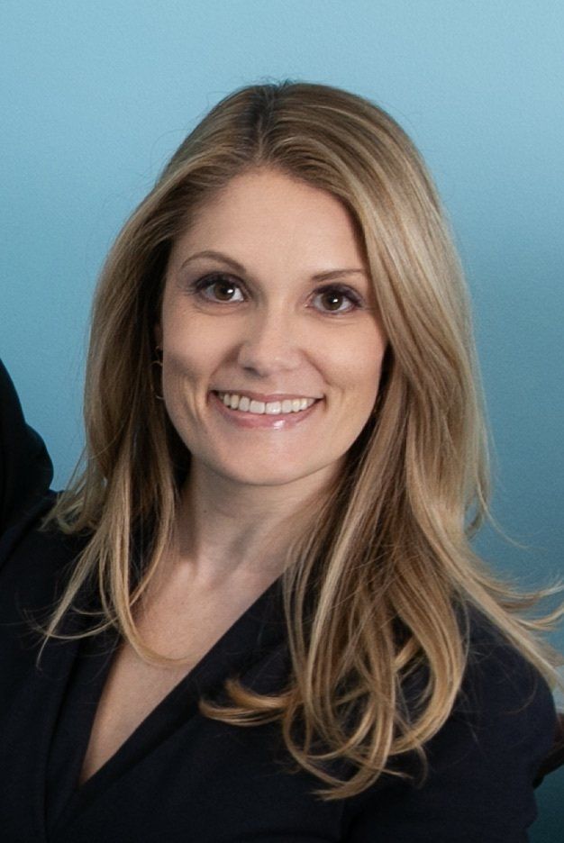 Dr. Andrea Fonner - Course Co-Director A woman with long blonde hair is smiling and wearing a black jacket.