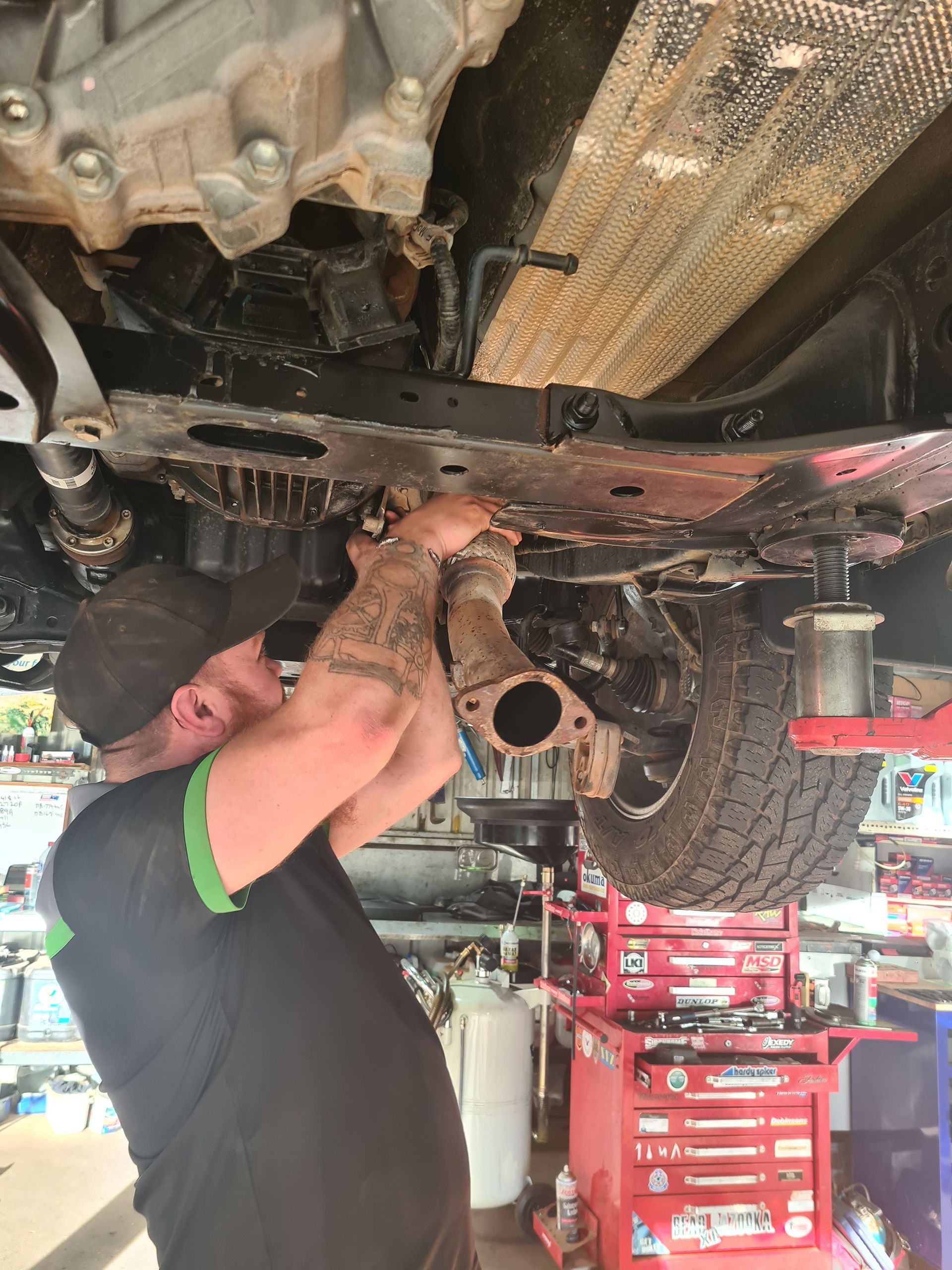 Mechanic Fixing Car on a Lift — Manjimup, WA — Manjimup Tyre Mart & Auto Electrical Services