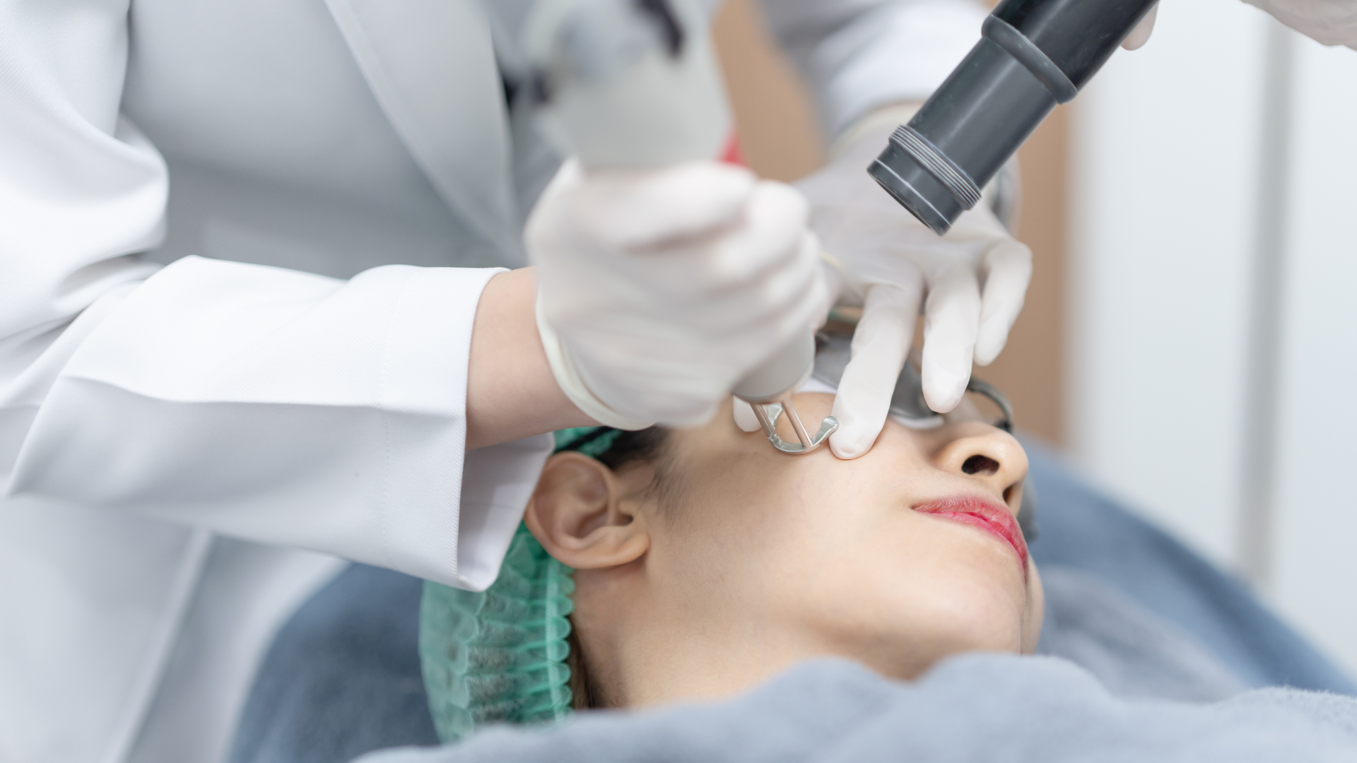 Dentist examining a patient’s eye with a dental instrument in a clinical setting