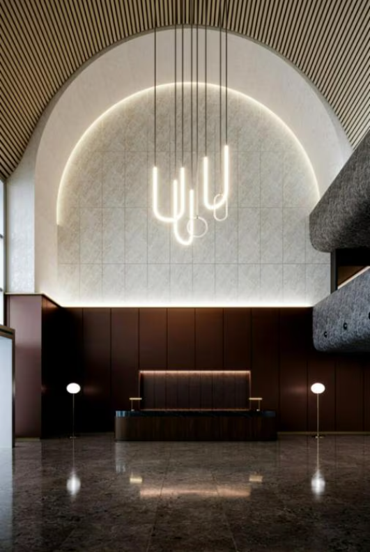 Elegant lobby with arched ceiling, hanging lights, dark brown accents, and reflective floor.