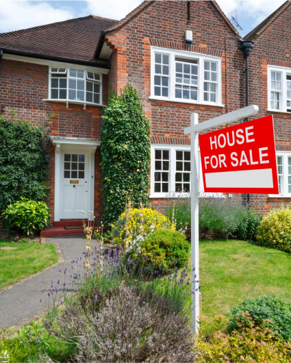 A house with a for sale sign in front of it