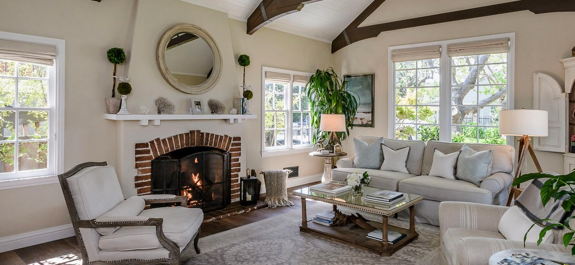 A living room filled with furniture and a fireplace.