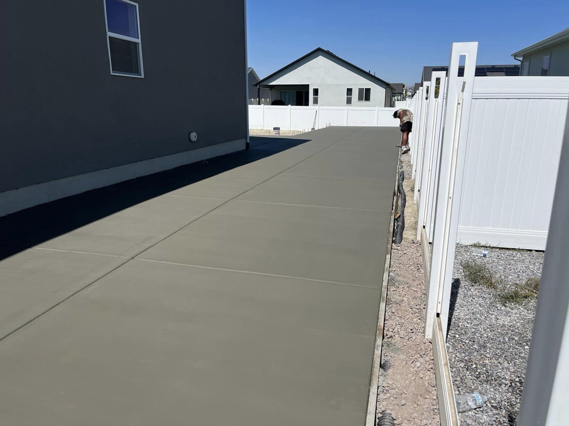 A driveway and backyard concrete patio extension