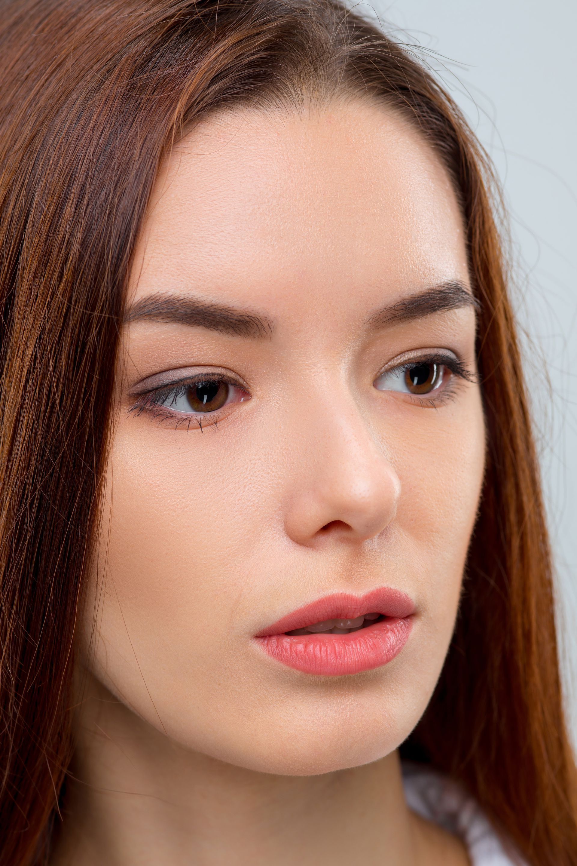 A close up of a woman 's face with long hair.
