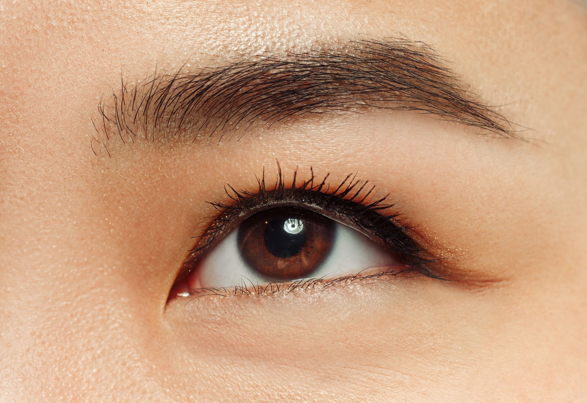 A close up of a woman 's eye with makeup on.