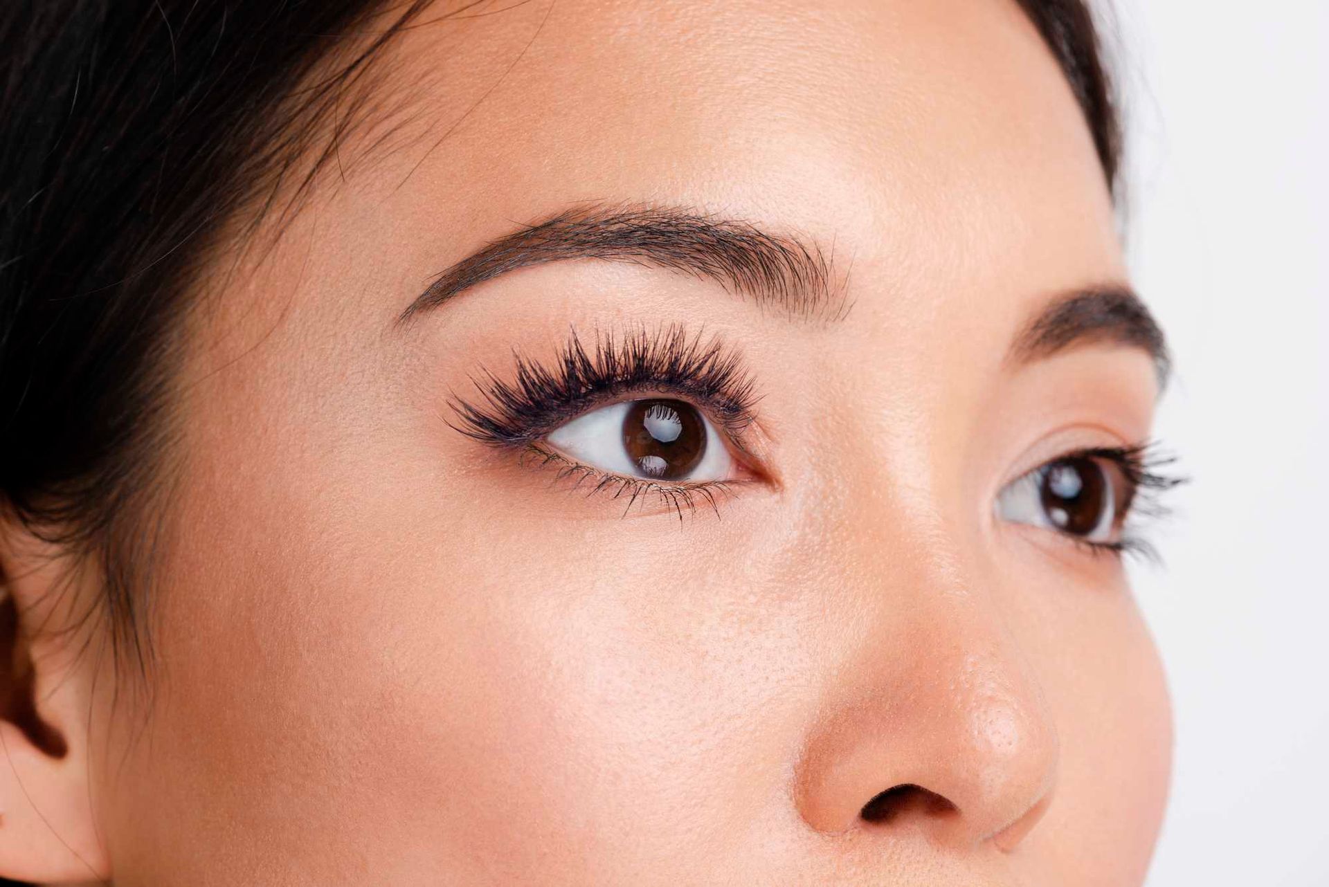 Close-up of a woman’s eyes with makeup, looking to the right