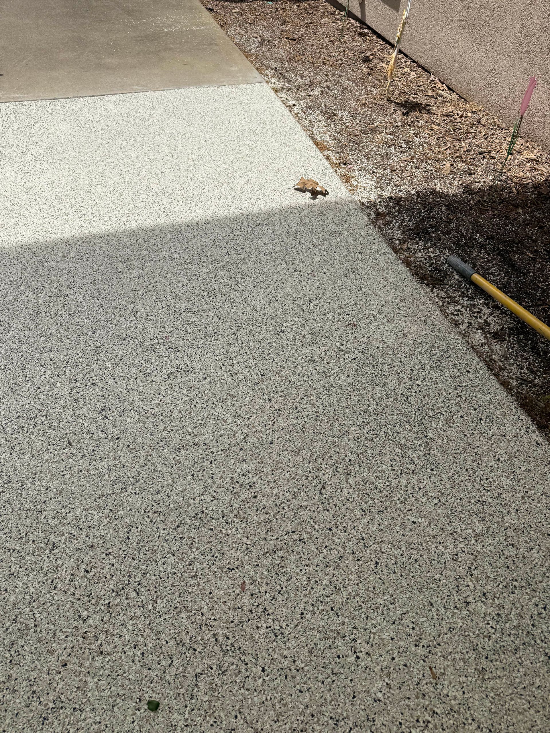 Durable epoxy flake surface on parking pad installed by Zachary Daniel Concrete in Rutherfordton, NC.