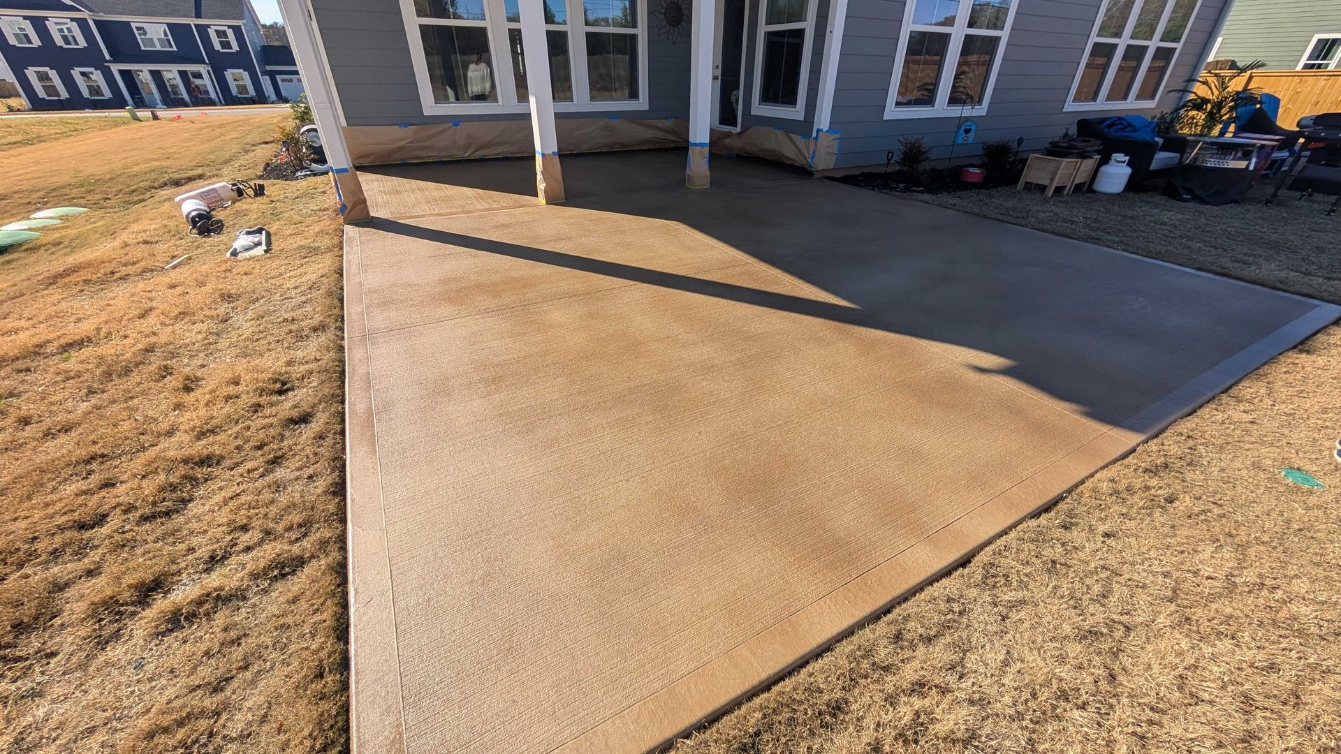 A concrete driveway is being built in front of a house.