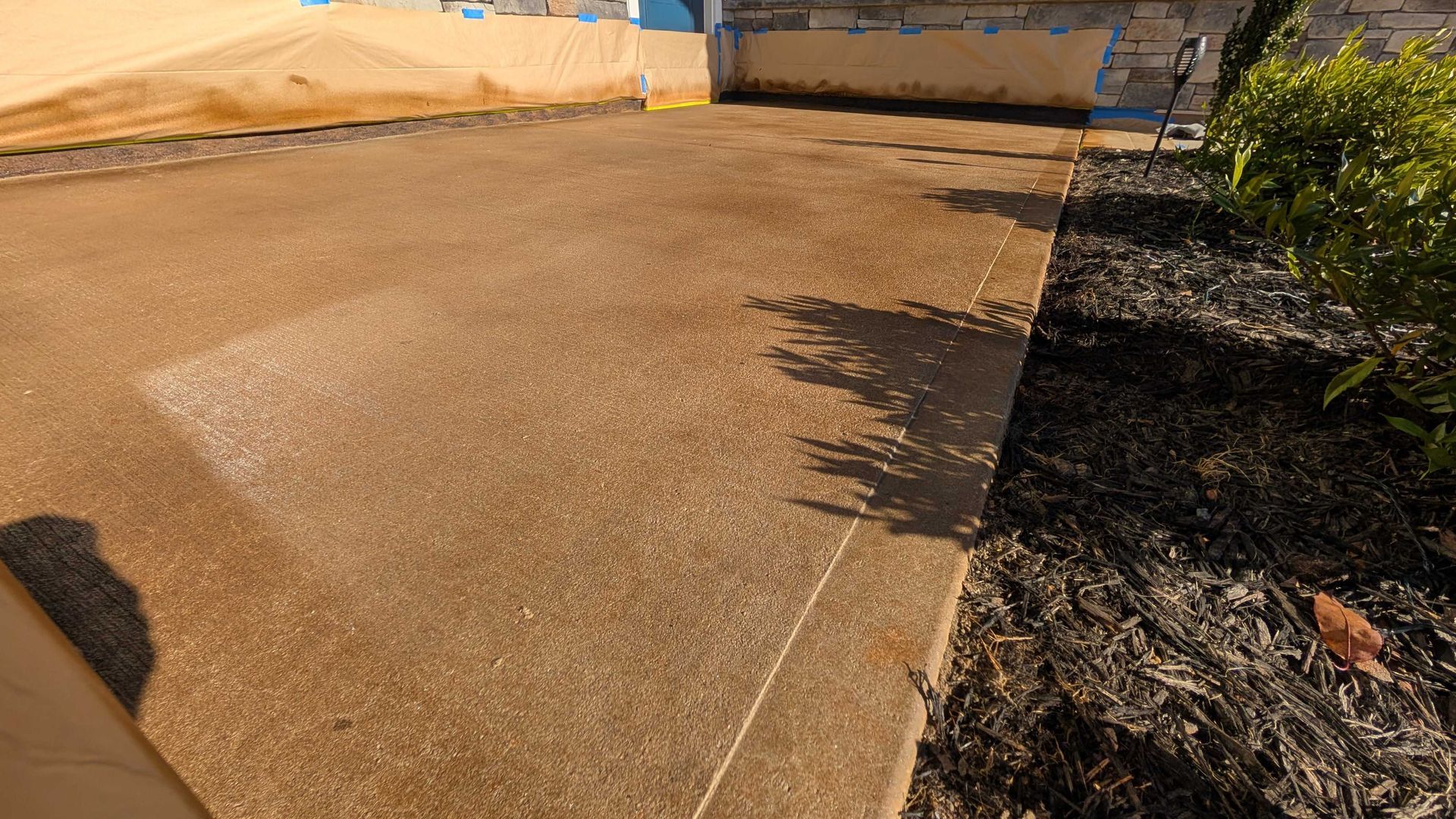 ChatGPT said:
Freshly stained and sealed concrete driveway with a warm brown finish in Greenville, SC.