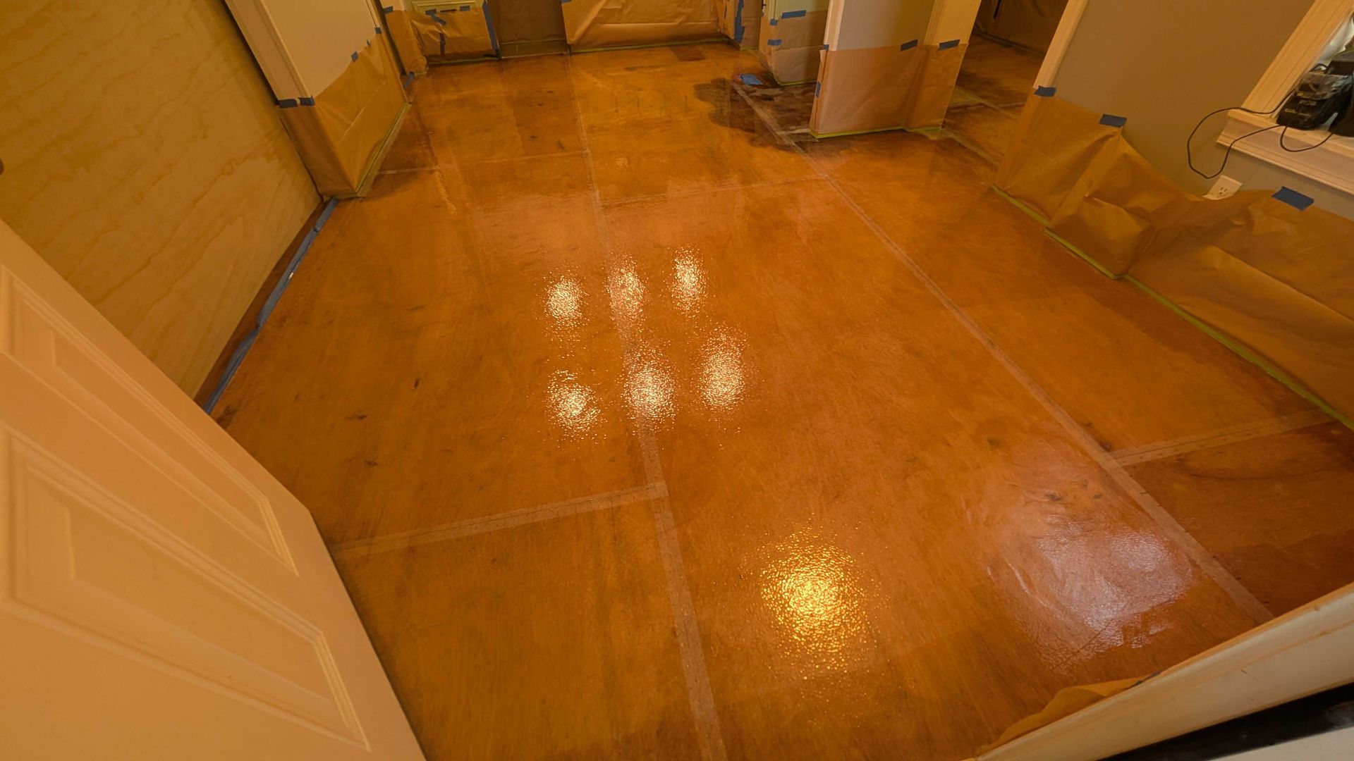 A room with a wooden floor and a door.