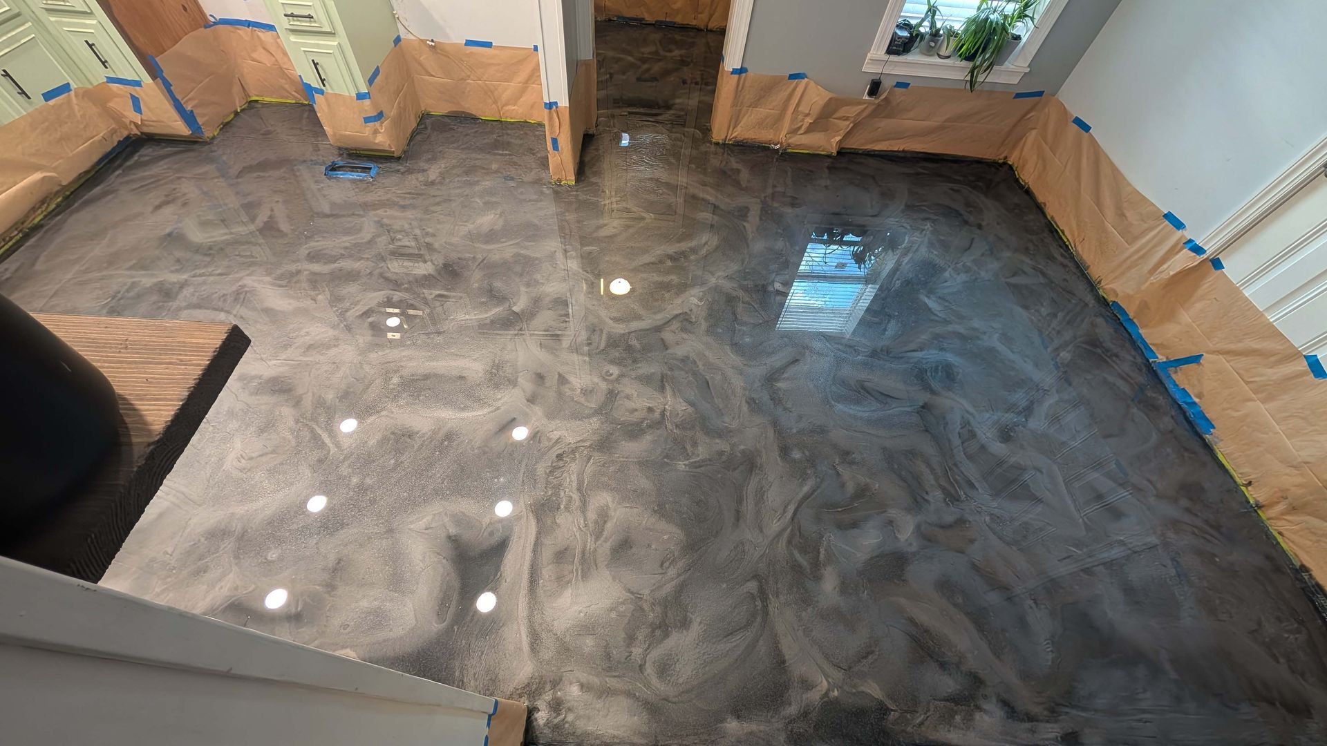 An aerial view of a kitchen with a shiny metallic floor.