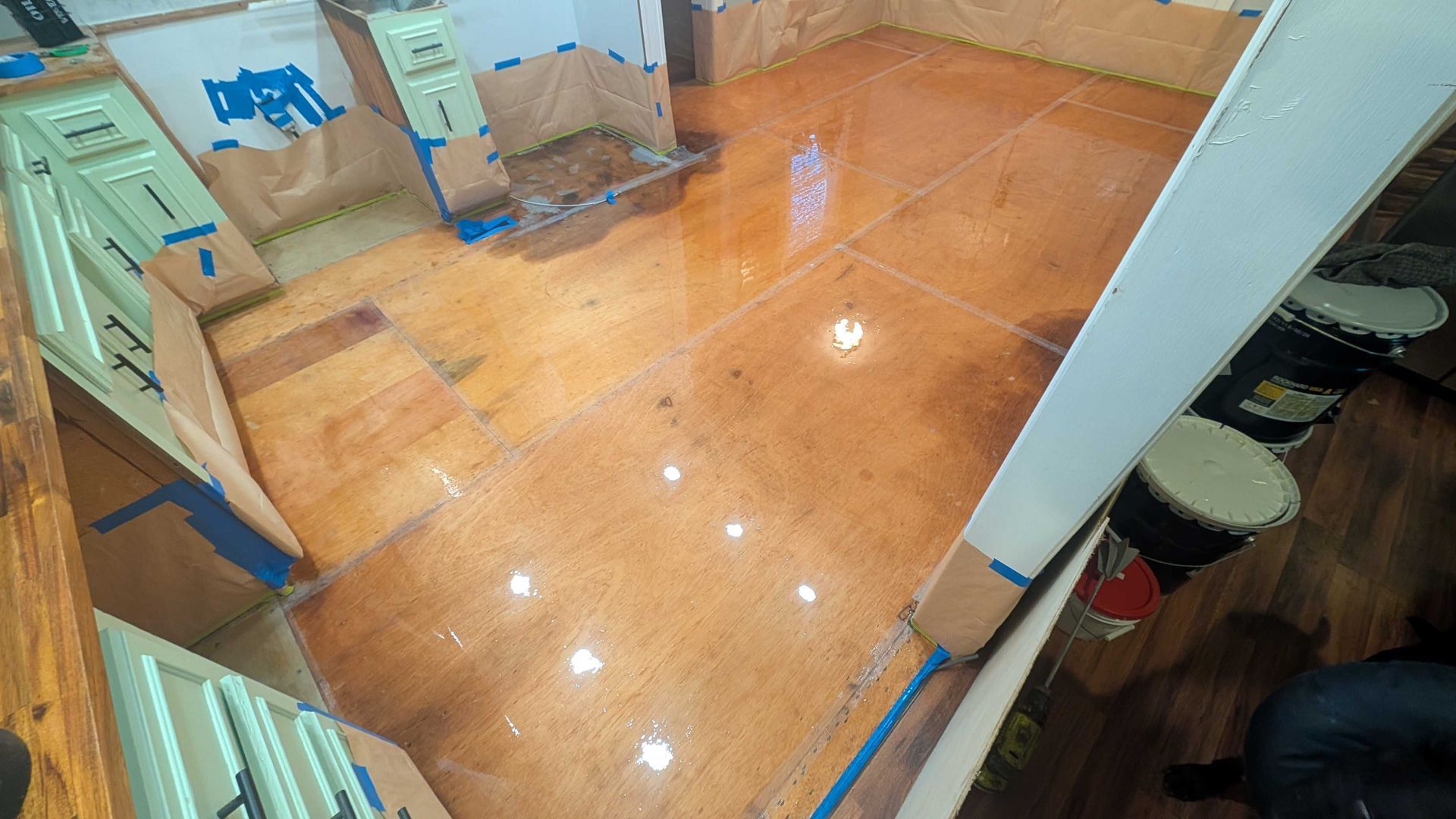 A room with a wooden floor and a mirror.
