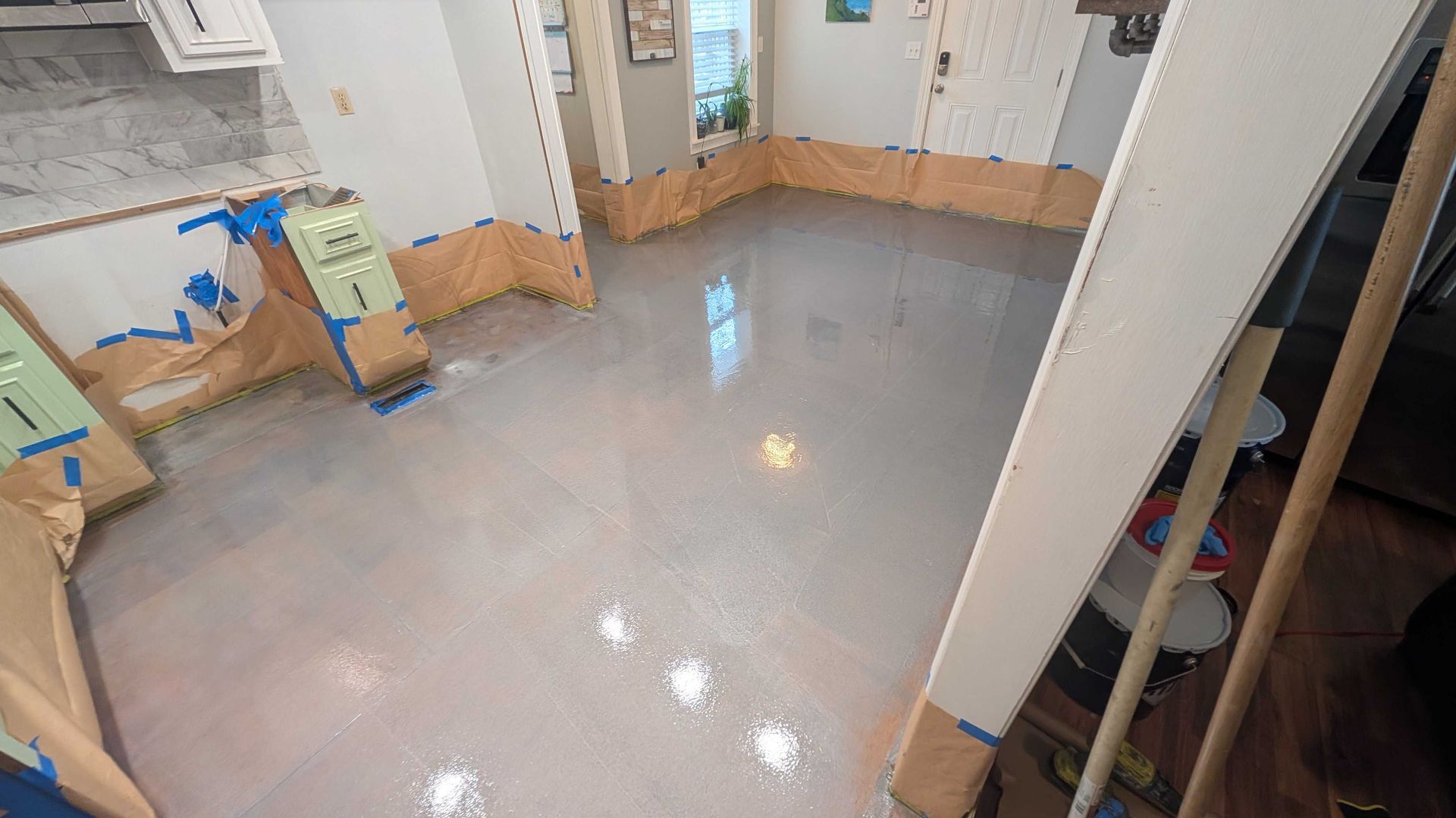A room with a concrete floor and a staircase.