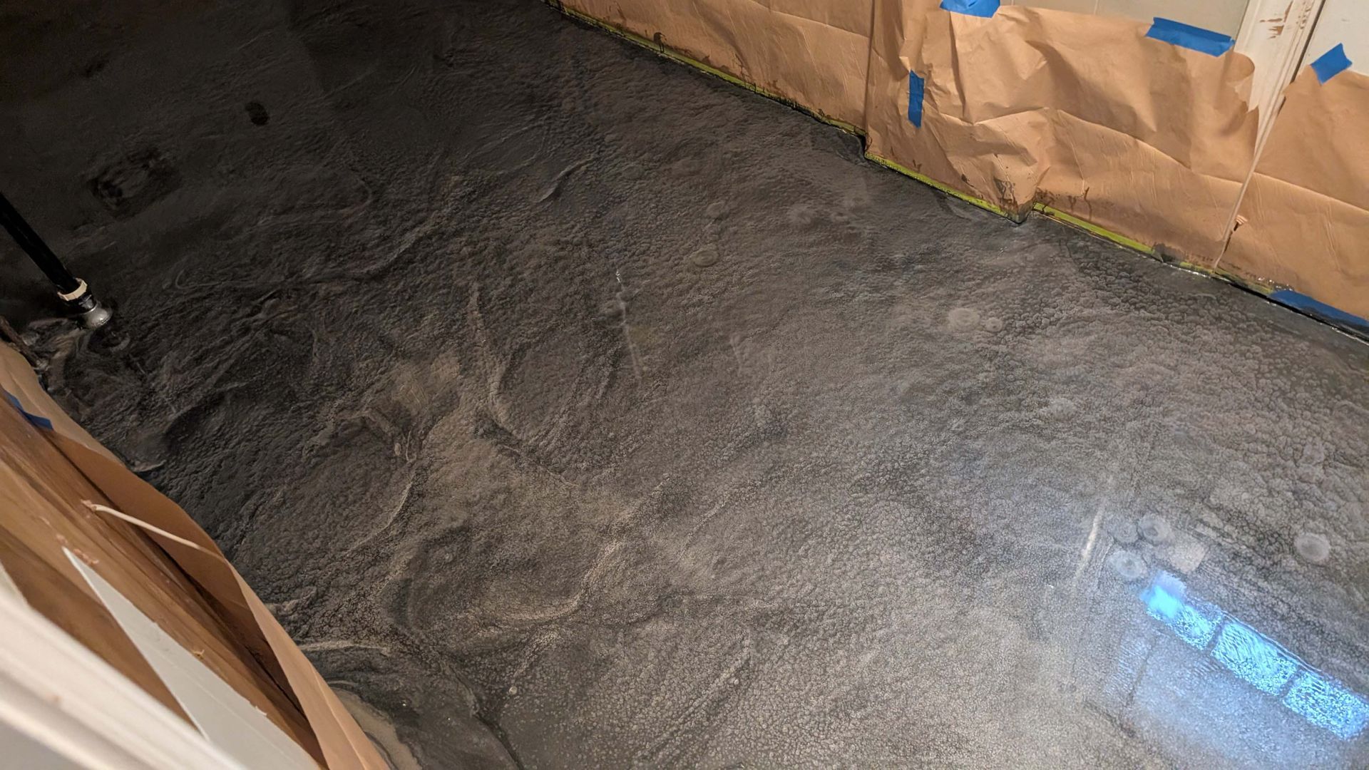 A room with a lot of concrete on the floor.