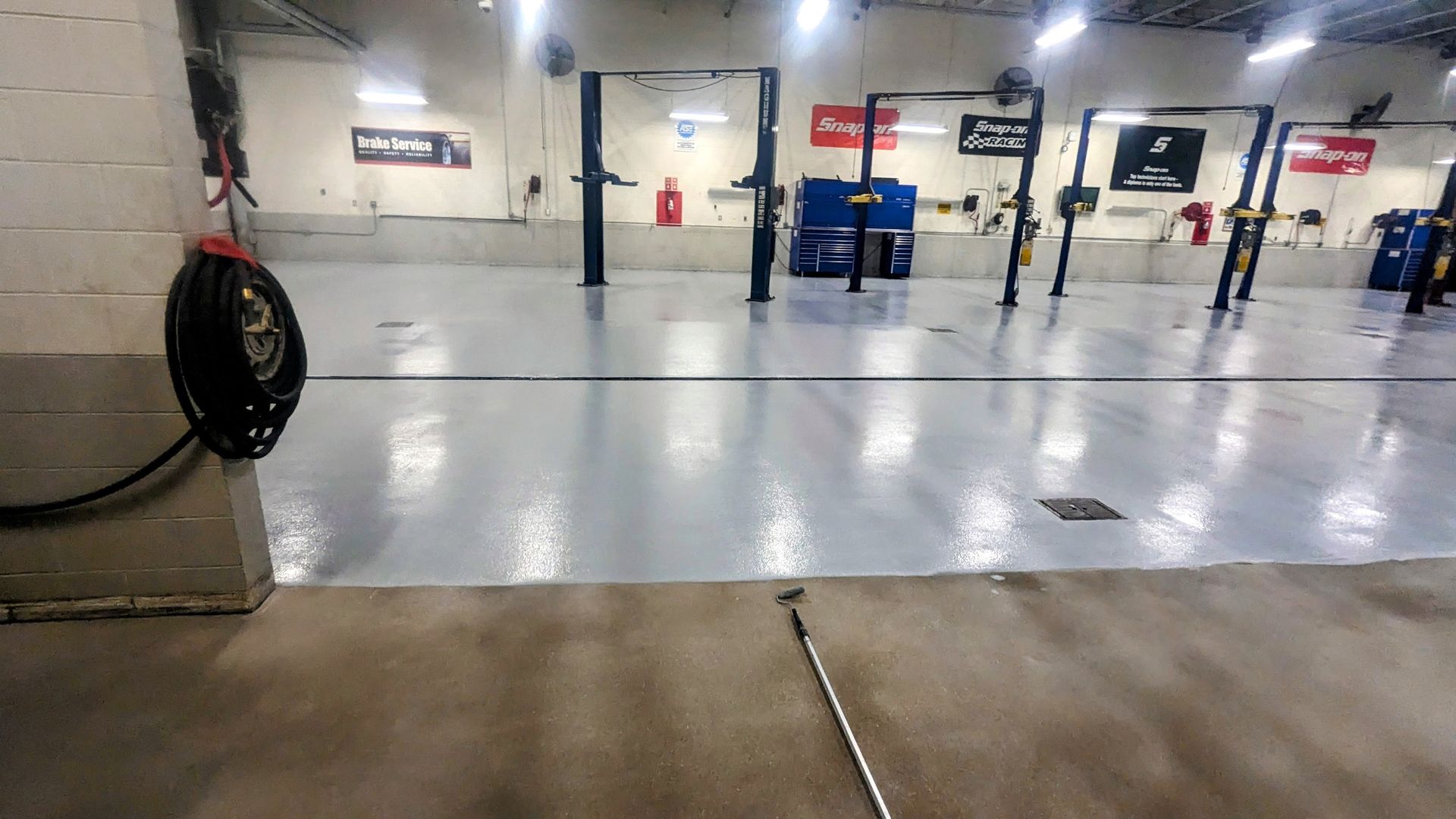 A large empty garage with a lot of lifts.