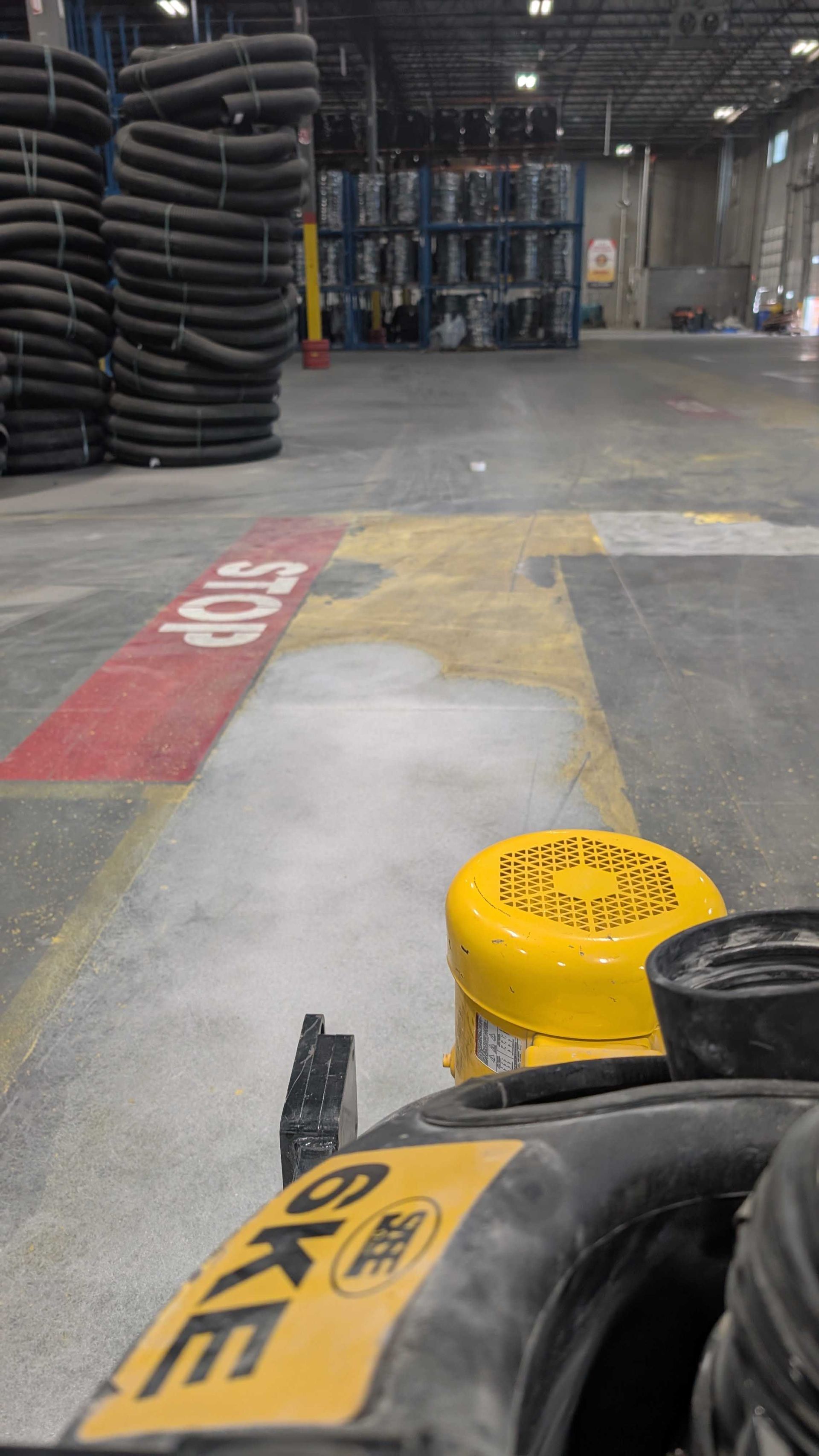 A close up of a machine 's wheel on a concrete floor.