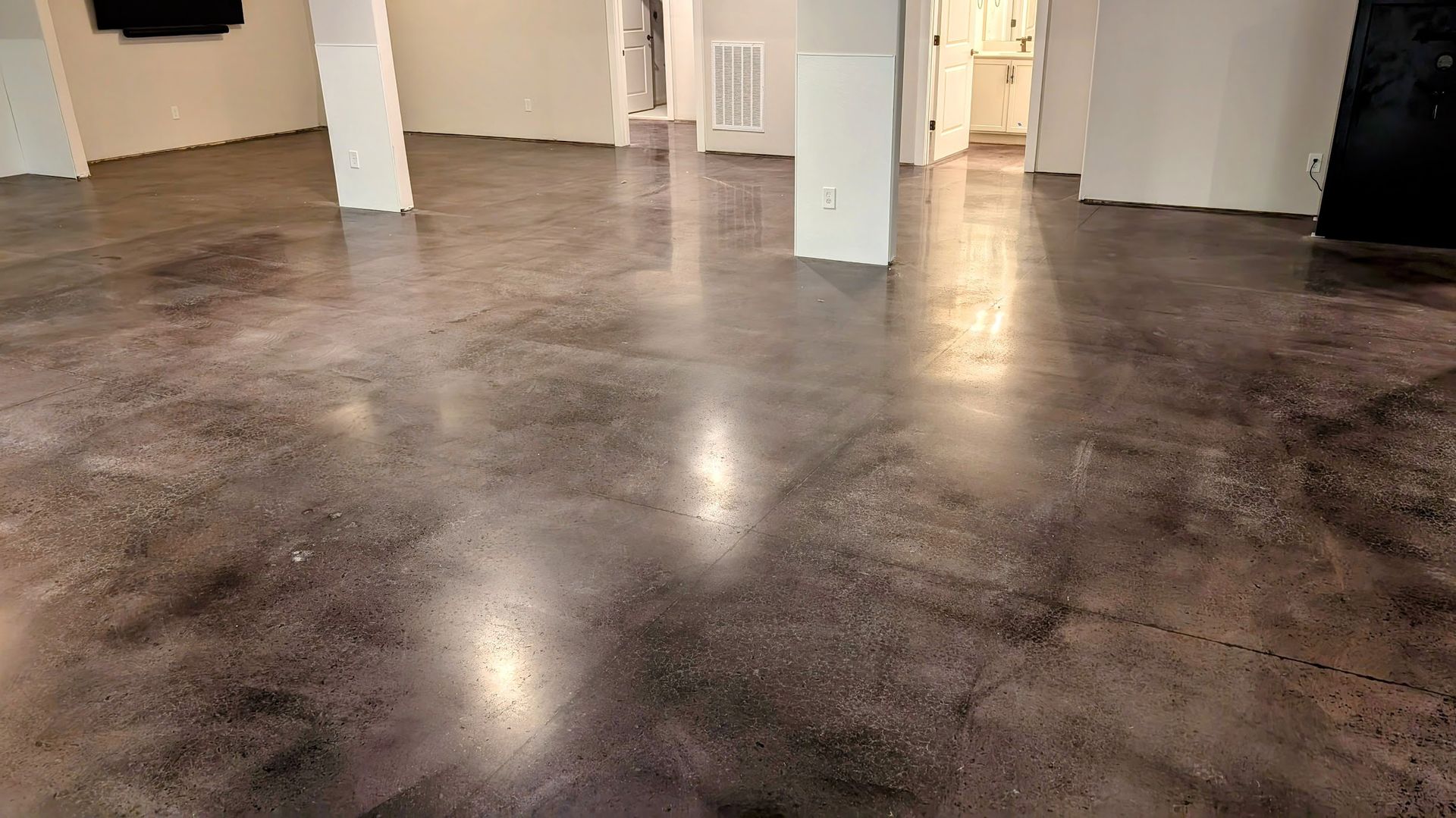 A large room with a concrete floor and white walls.