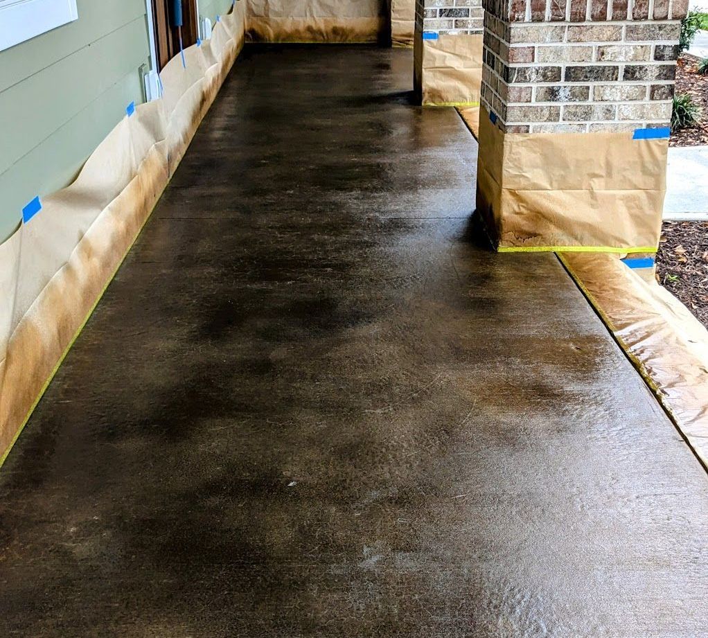 A concrete floor in a garage is being painted.