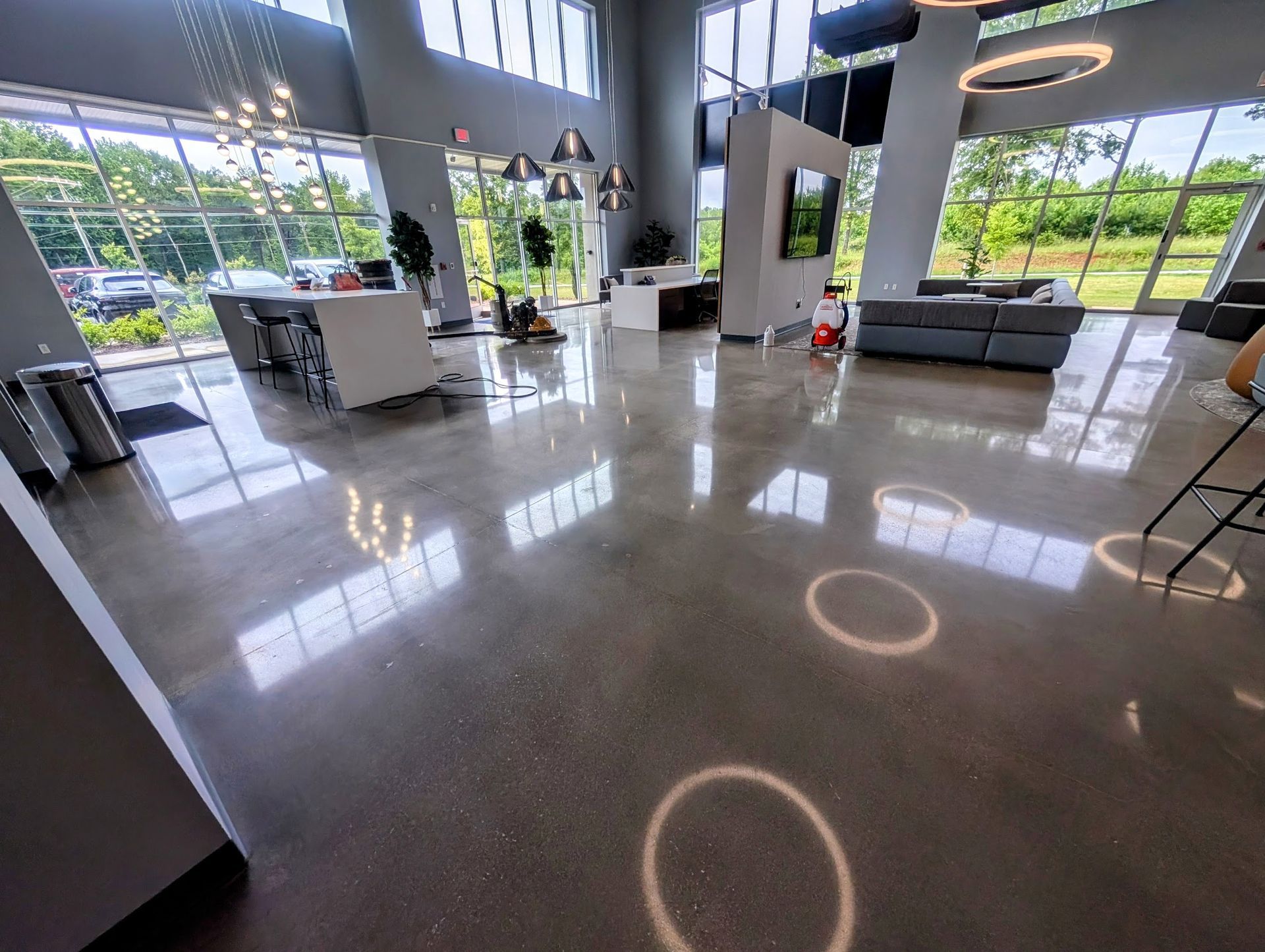A close up of a concrete floor with a reflection of lights.