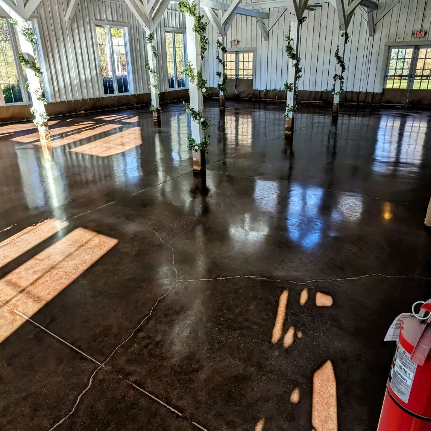 A large room with a fire extinguisher on the floor
