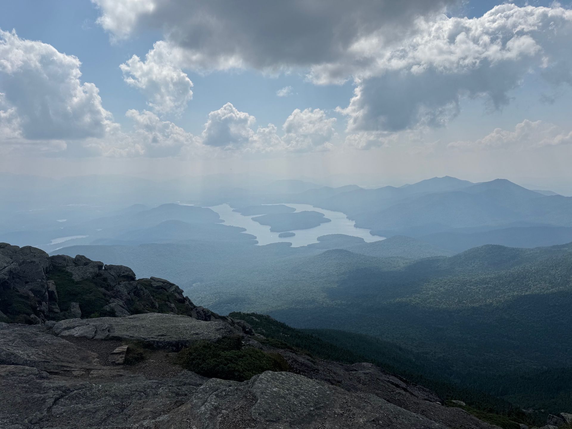 The view from the top of Whiteface Mountain showing the entirety of Lake Placid and mountains.